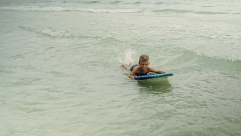 Little boy with surf board having fun in the ocean. Panama City Beach USA Stock-Footage 123978433