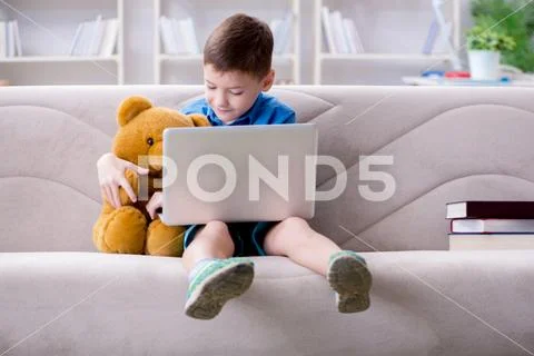 Little boy surfing internet on laptop Stock Photos