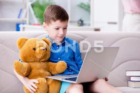 Little boy surfing internet on laptop Stock Photos