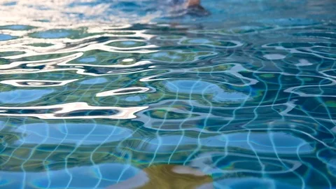 A little boy swims in the pool, smiling Stock Footage 82390923