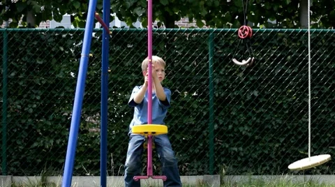 Little boy on swing Stock Footage 7340161