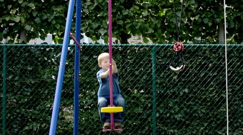 Little boy on swing Stock Footage 7340216