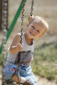 Little boy on a swing Stock Photos