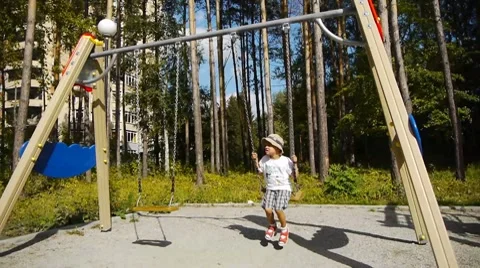 Little boy swinging Stock Footage 8835491