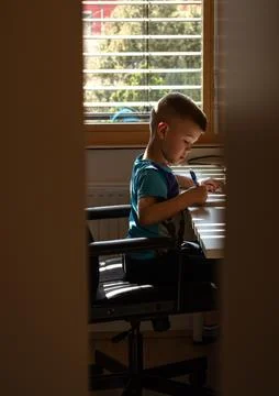 Little boy at the table doing homework Stock Photos