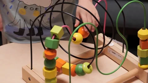 A little boy at the table playing with blocks and bead puzzle games Stock Footage 157532124