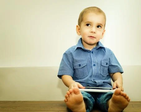 Little boy with tablet computer in the hands of Stock Photos
