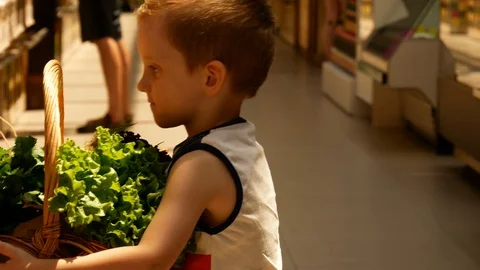 Little boy take the basket with products Stock Footage