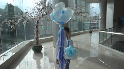 Little boy taking balloon floating up slow motion HD Stockbeeldmateriaal 65800520