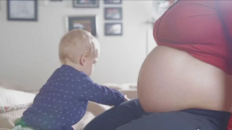 Little boy is taking care of his unborn brother. FULL HD. Video stock 73962409