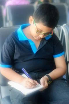 Little boy taking notes Stock Photos