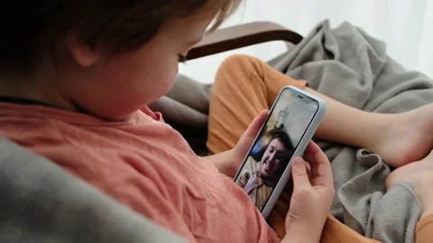Little boy talks with father using videocall on smartphone Stock Footage 142435969