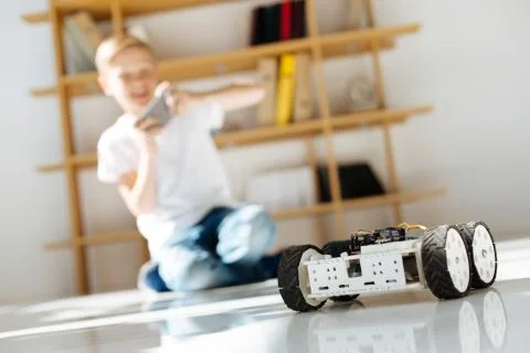 Little boy testing his robotic vehicle toy Stock Photos