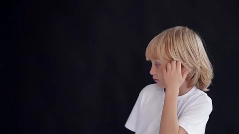 A little boy thoughtfully scratches his head Stock Footage 145190856