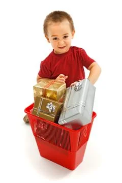 Little boy throwing presents in garbage bin Stock Photos