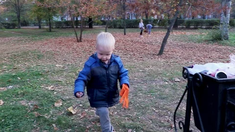 A little boy throws garbage in the trash in the street. The concept of waste man Stock-Footage 97720998