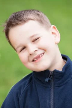 Little boy with a torn front first milk tooth Stock Photos