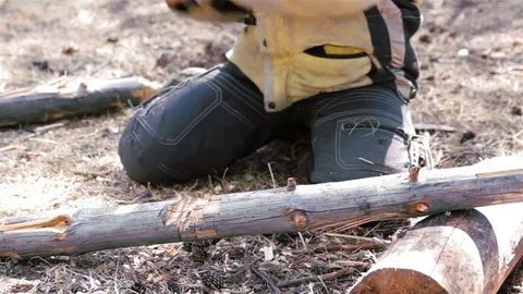 Little boy try to cut in half the log. He hold axe in two hands and hit hard Stock Footage