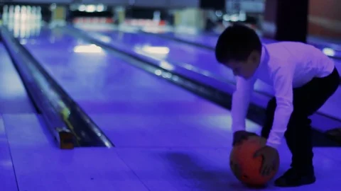 Little boy try to play a game of bowling Stock Footage 83644255