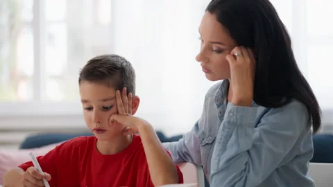 Little boy trying to solve math problem, private lesson with tutor at home Stock Footage 230919904