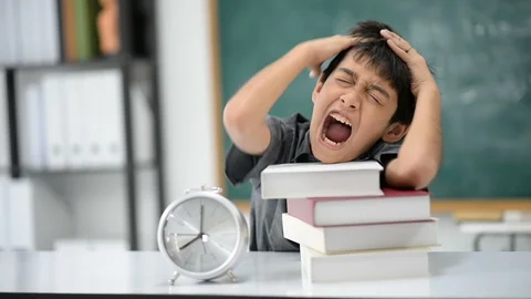 Little boy turning round clock in the classroom Stockbeeldmateriaal 105273133