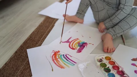 Little boy of two years old draws with paints sitting on the floor Stock Footage 168090406