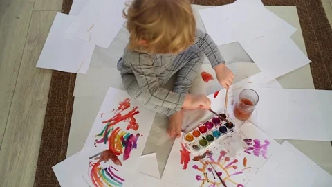 Little boy of two years old draws with paints sitting on the floor Stock Footage 168092245