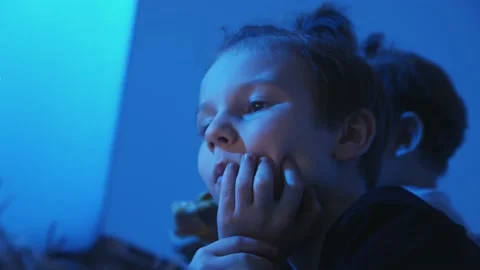 Little boy uses notebook and eats pizza in bed at night Stock Footage 150968279