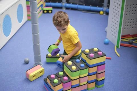 Little boy using blocks building rocket. Kids learning and development concept Stock Photos