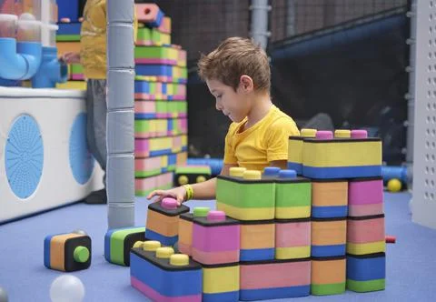 Little boy using blocks building rocket. Kids learning and development concept Stock Photos