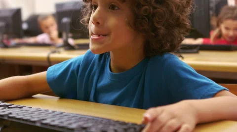 Little boy using computer in classroom in school 스톡 동영상 56881435