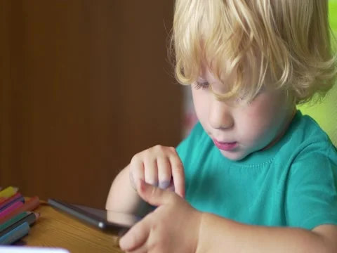 Little Boy Using A Digital Tablet Stockbeeldmateriaal 54374908