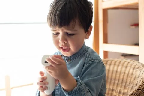 Little boy using a digital thermometer Stock Photos