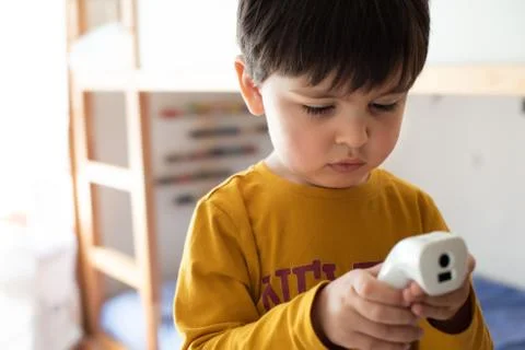 Little boy using a digital thermometer Stock Photos