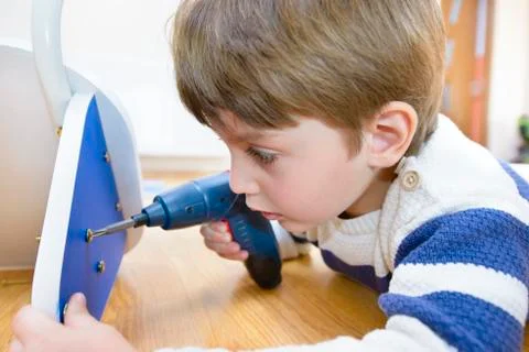 Little boy using diy tool at home Stock Photos