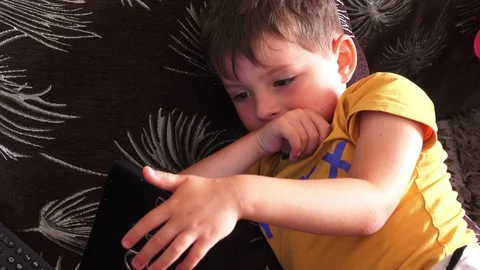 Little boy using mobile gadget Stock Footage 94928650