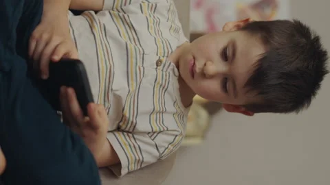Little boy using smart phone in the living room. Education and learning concept Video stock 246390547