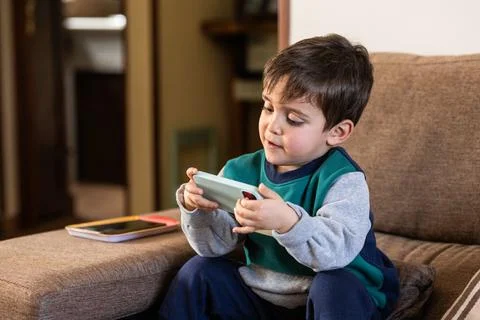Little Boy Using a Smartphone, Exploring the Digital World Stock Photos