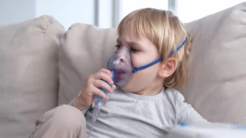 Little boy using steam inhaler nebulizer. health medical care. Stock Footage 276182962