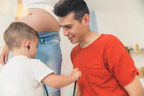 Little boy using a stethoscope to listen to the heartbeat of his dad Stock Photos