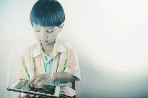 Little boy is using tablet with digital coding and education concept Stock Photos