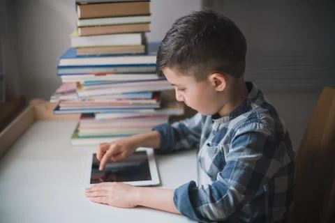 Little boy is using a tablet. Stock Photos