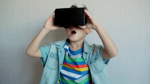 Little boy using virtual reality device in studio Stock Footage 70575154