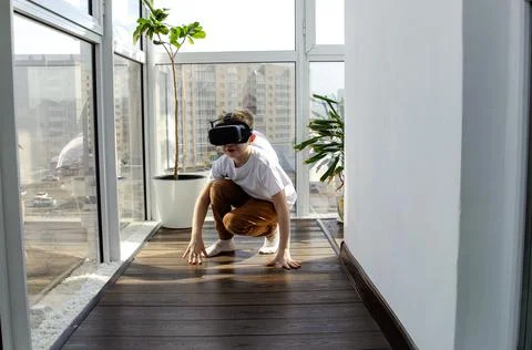 Little boy using a VR headset to play fighting game. Child with virtual reali Stock Photos