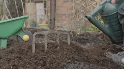 Little Boy Using A Watering Can To Water Seeds Stock Footage 60794412