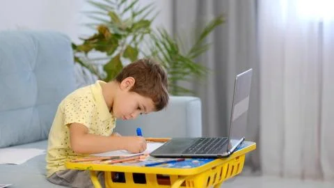 Little boy in virtual class. School at home. little cute boy is taking an online Stock Photos