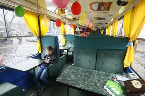 Little boy waiting for lesson in a tram compartment converted in a club and.. Stock Photos