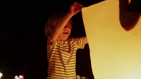 Little Boy Waiting To Release A Lantern At Night Stock Footage 305507608