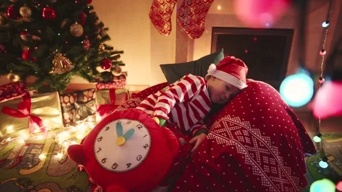 Little boy waiting for Santa Claus on Christmas night Stock Footage 73003161