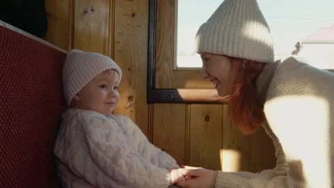 Little boy waits on dark train as mother approaches for a warm moment Stock Footage 346717423